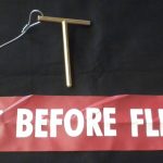 Safety-red remove-before-flight streamer and pin assembly used for aircraft maintenance while on ground
